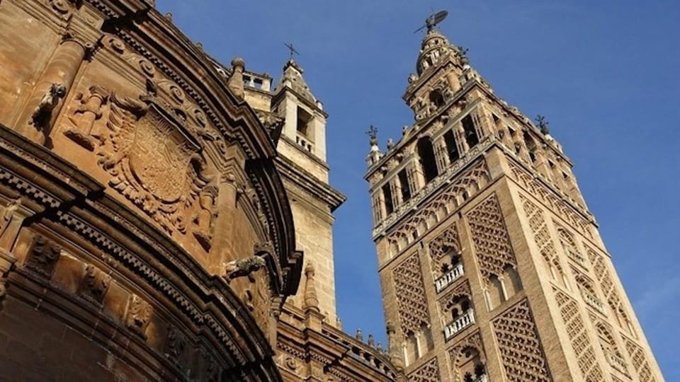 Seville Cathedral and Giralda Tower Guided Tour and Tickets - Giralda Tower: 35 ramps, panoramic views, and a crowd at the top