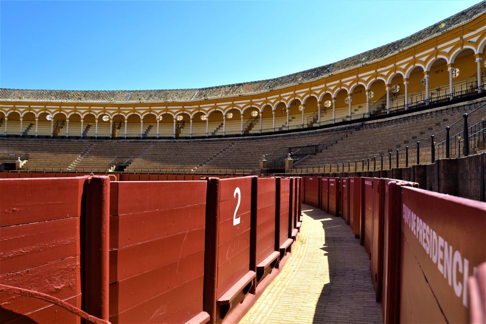 Seville: Plaza de Toros and Barrio Santa Cruz Tour - Barrio Santa Cruz Walking: narrow lanes, legends, and Patio de Banderas