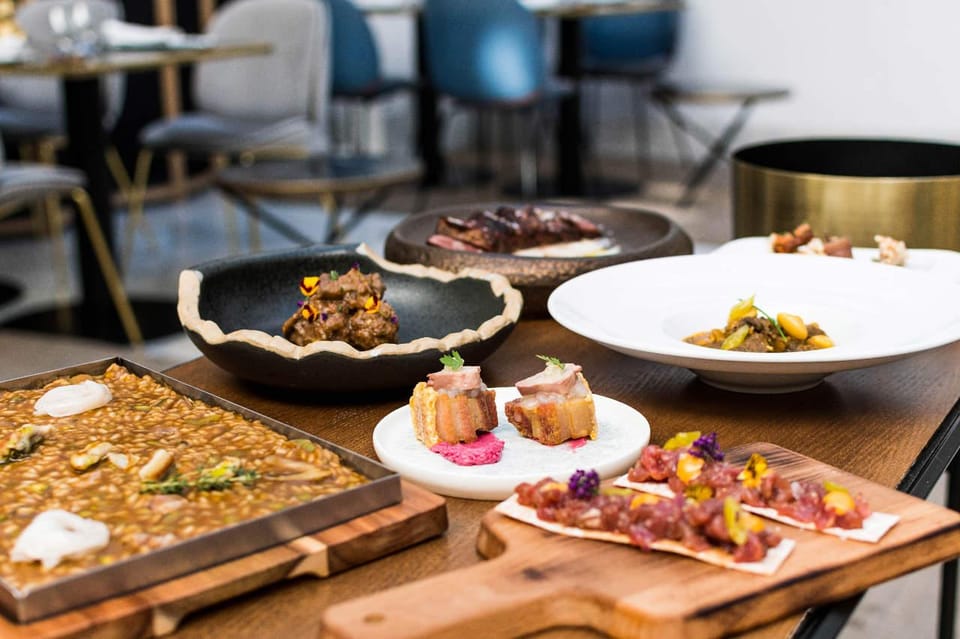Seville with a Michelin Chef: Gastronomic Tour around Secret Corners - Plaza Nueva pickup and the short walking route through Seville’s center