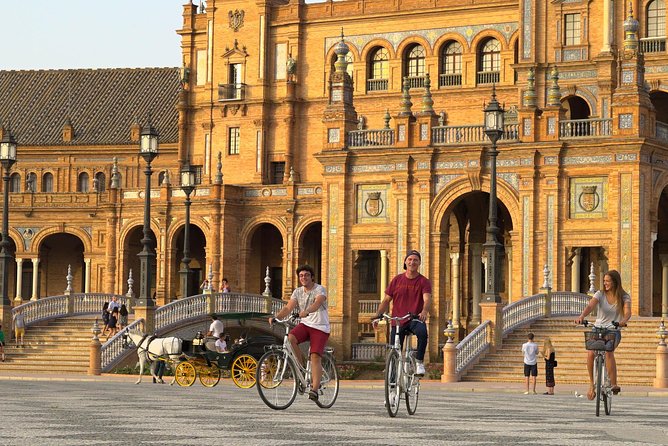 Sunset Guided Bike Tour in Seville - Torre del Oro and the Giralda: two skyline icons with different stories